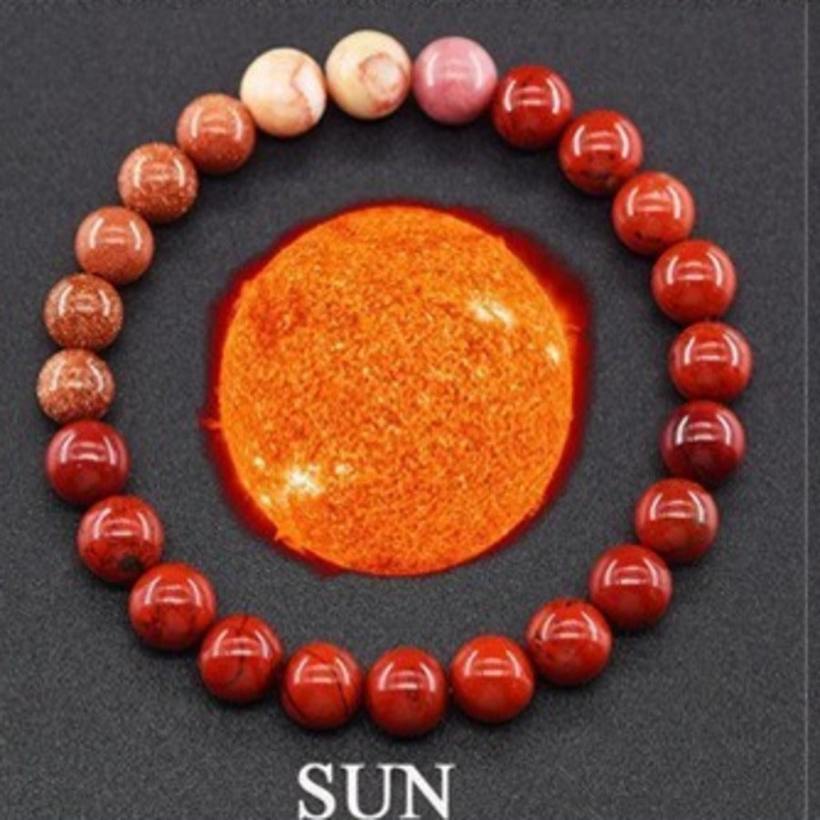 Solar Core planet gemstone bracelet with red agate and gold-tone accents by Velastrand