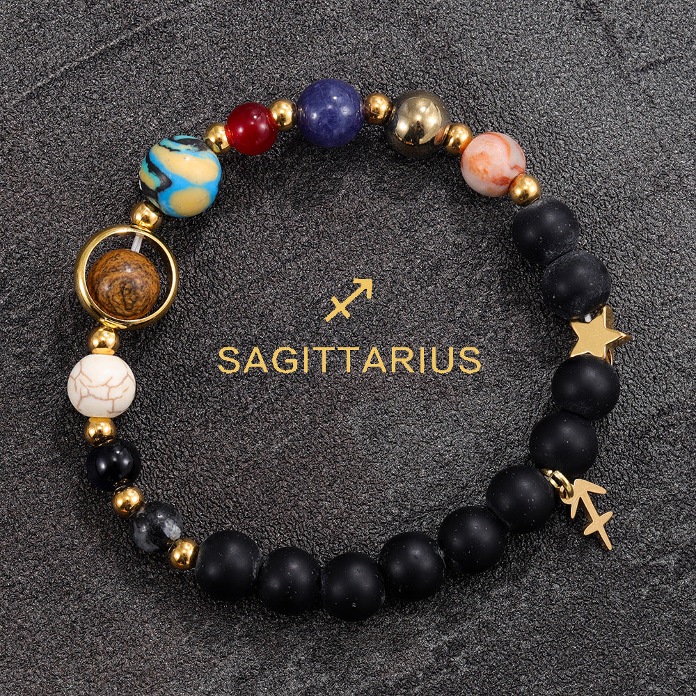 Sagittarius zodiac gemstone bracelet with Jupiter blue, red agate, black onyx, and gold-tone charm by Velastrand