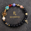 Scorpio zodiac gemstone bracelet with deep blue, coral red, black onyx, and gold-tone charm by Velastrand