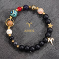 Aries zodiac gemstone bracelet with red agate, cobalt, black onyx, and gold-tone charm by Velastrand