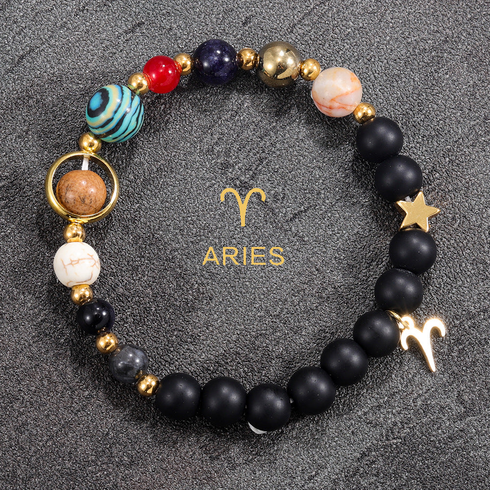Aries zodiac gemstone bracelet with red agate, cobalt, black onyx, and gold-tone charm by Velastrand