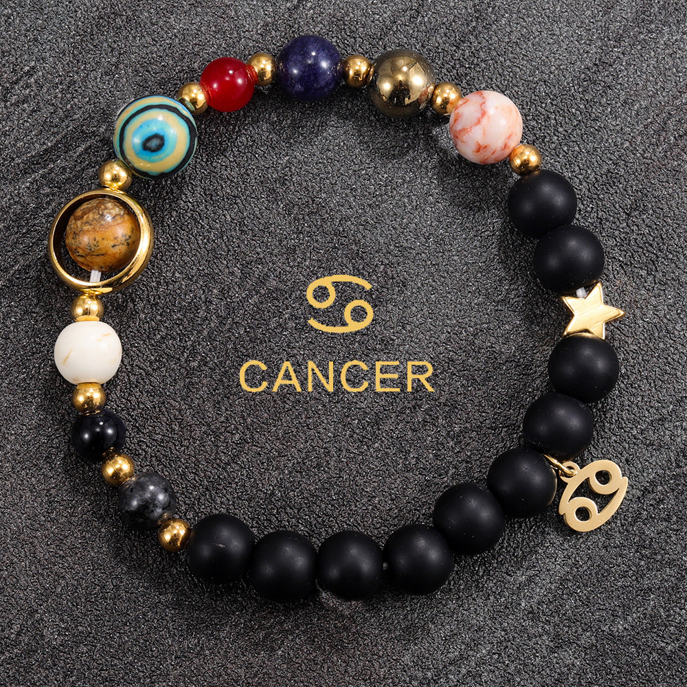 Cancer zodiac gemstone bracelet with ocean blue, rose quartz, black onyx, and gold-tone charm by Velastrand