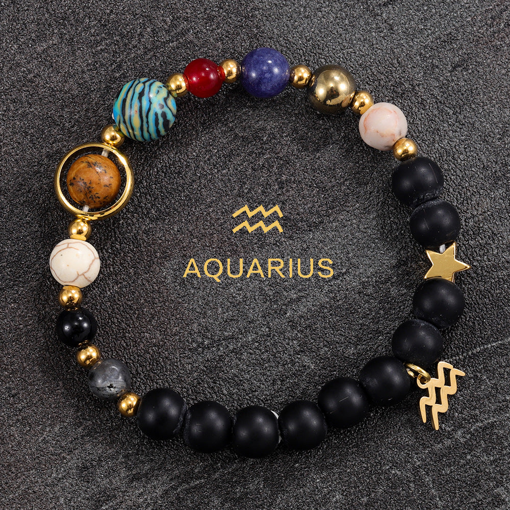 Aquarius zodiac gemstone bracelet with turquoise, black onyx, and gold-tone charm by Velastrand